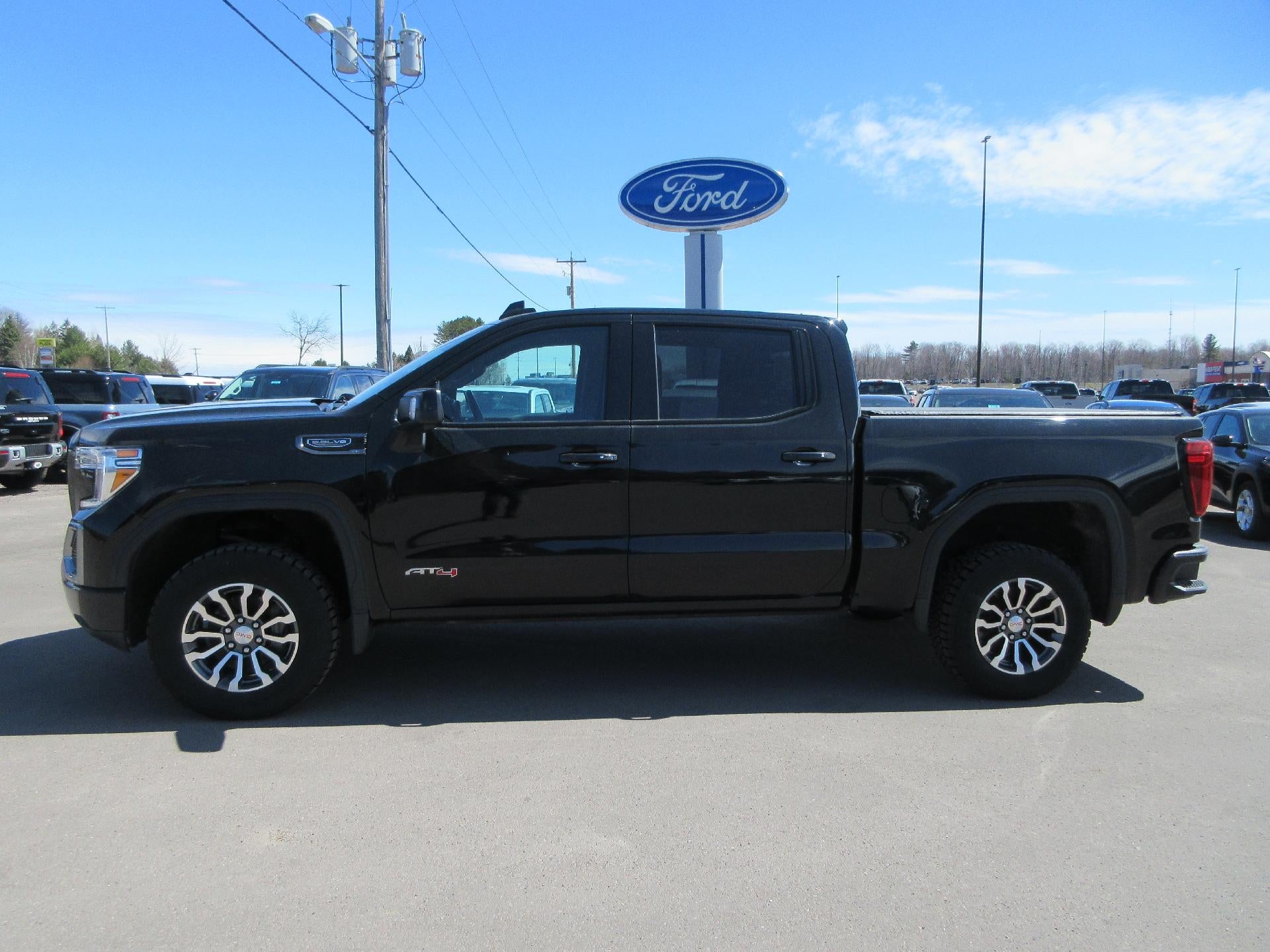 2021 GMC Sierra 1500 Crew Cab Short Box 4-Wheel Drive AT4 in Onyx Black — front three-quarter view